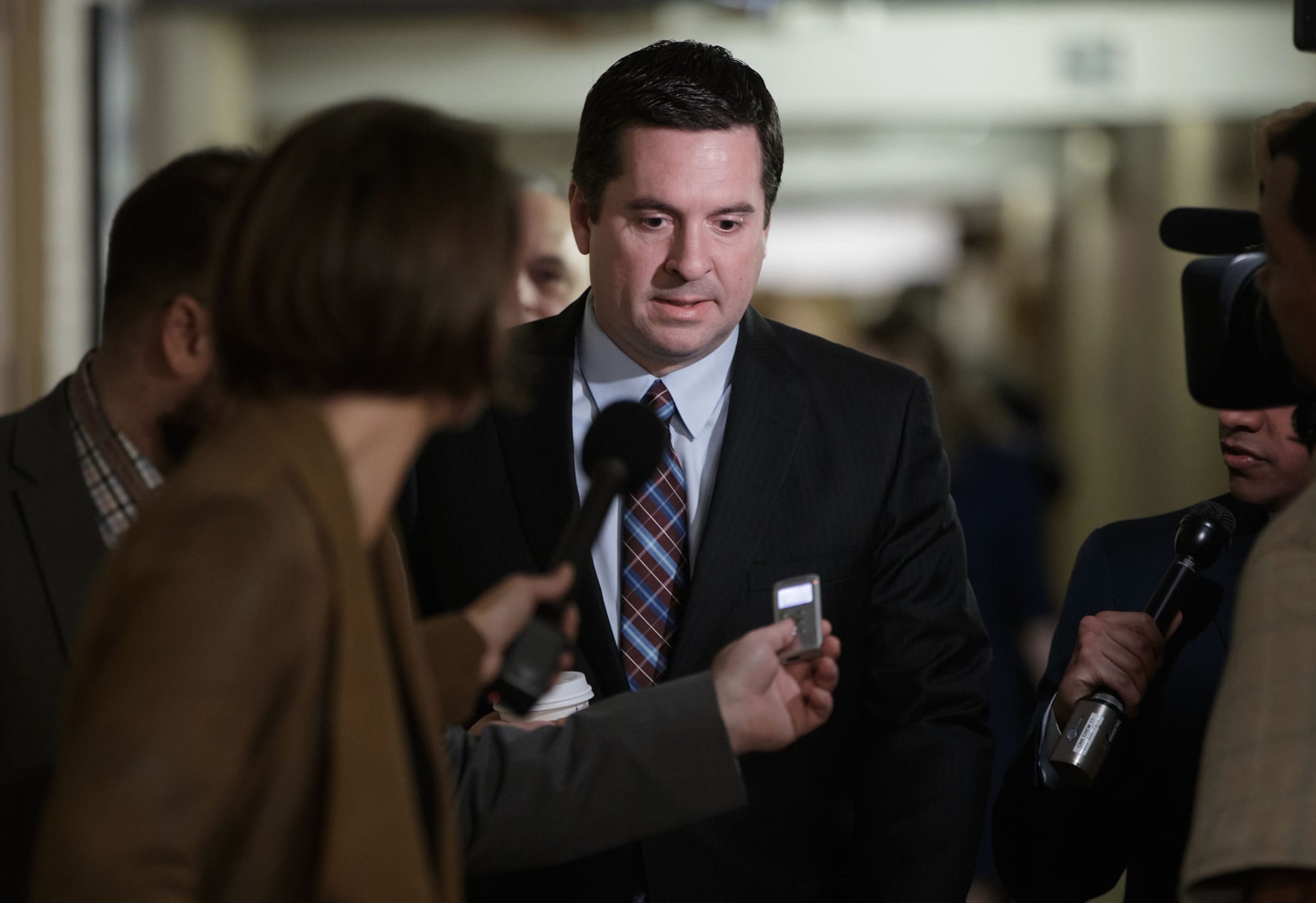 House Intelligence Committee Chairman Rep. Devin Nunes, R-Calif. is pursued by reporters as he arrives for a weekly meeting of the Republican Conference with House Speaker Paul Ryan and the GOP leadership, Tuesday, March 28, 2017, on Capitol Hill in Washington. Nunes is facing growing calls to step away from the panel's Russia investigation as revelations about a secret source meeting on White House grounds raised questions about his and the panel's independence. (AP Photo/J.
