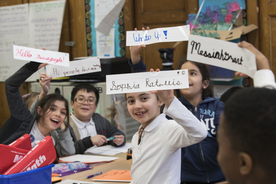 Students display some of their cursive writing work and exercises at P.S. 166 in the Queens borough of New York. Cursive writing is looping back into style in schools across the country after a generation of students who know only keyboarding, texting and printing out their words longhand.