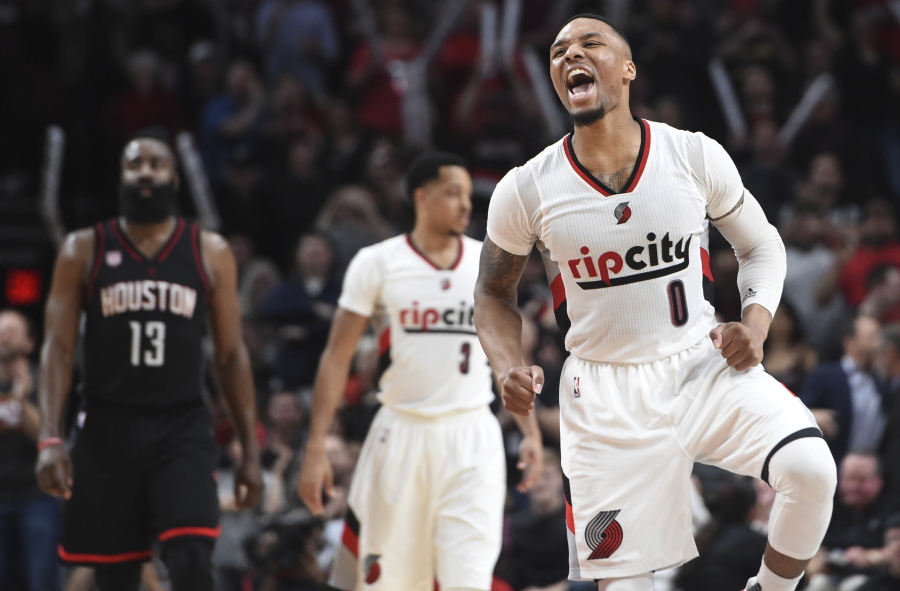 Portland Trail Blazers guard Damian Lillard celebrates as the Blazers take the lead late during the fourth quarter of an NBA basketball game against the Houston Rockets in Portland, Ore., Thursday, March 30, 2017. The Blazers won 117-107.