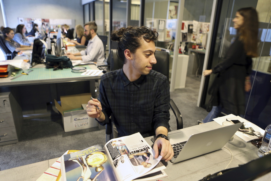 Mohammad Hazem Rezq, one of the Vogue staff, works at his desk at the magazine office in the Dubai Design District in Dubai, United Arab Emirates.