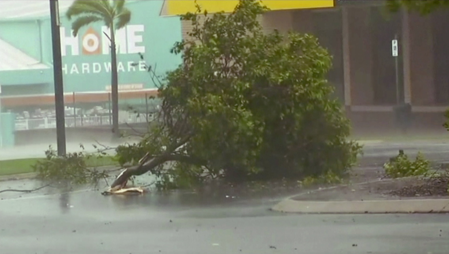 In this image made from video, tree debris lies on the street as wind gusts Tuesday in Bowen, eastern Australia. A powerful cyclone lashed islands, damaged roofs and cut power on Tuesday as it edged toward Australia&#039;s tropical northeast coast, officials said. Thousands of households were left without power.
