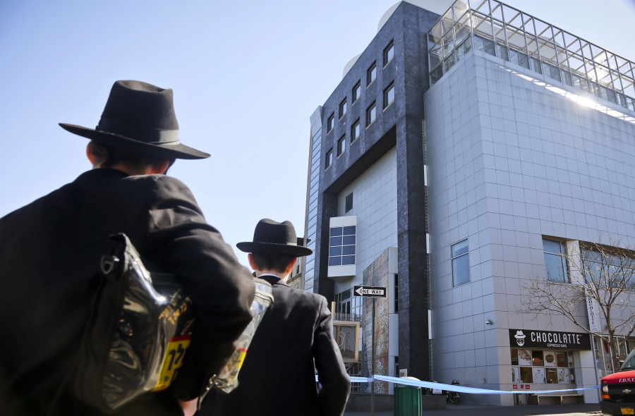 Two young men who left a nearby synagogue watch police activity outside the Jewish Children&#039;s Museum following a bomb threat in Brooklyn borough of New York on March 9, 2017. Jewish groups who warned of a surge in anti-Semitism had pointed to numerous bomb threats against Jewish community centers as the most dramatic example of the trend. Now authorities say an Israeli Jewish teen is responsible, potentially undermining the community???s fight against bigotry and embarrassing those who blamed a far-right emboldened by President Donald Trump.