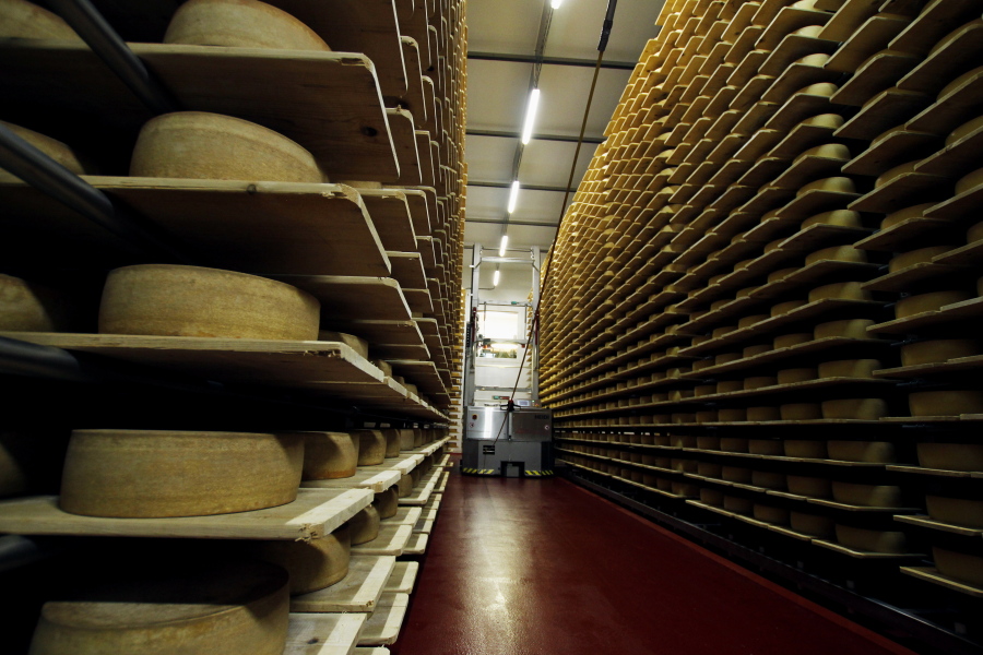In this Feb. 27, 2017, photo, wheels of Grand Cru Surchoix cheese sit on spruce planks to age for nine months at the Emmi Roth USA production plant in Monroe, Wis. The company won the World Championship Cheese Contest in 2016 for the cheese and since then has seen an increase in sales of the cheese. The contest is organized by the Wisconsin Cheese Makers Association, which also organizes the United States Championship Cheese Contest that runs until March 9 in Green Bay, Wis. The contests are in alternate years.