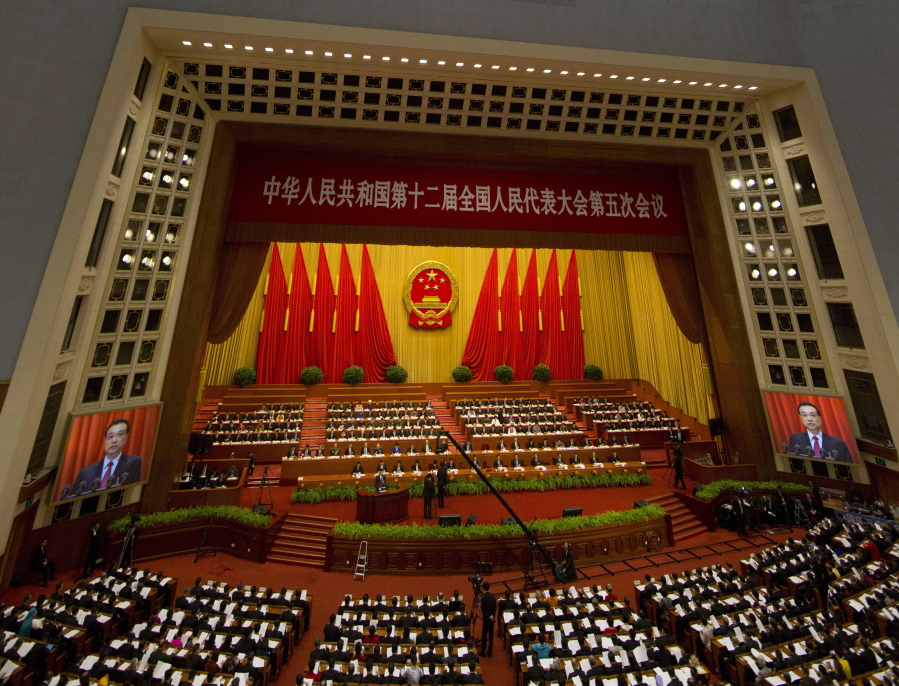 Chinese Premier Li Keqiang is displayed on screens Sunday as he delivers a work report at the opening session of the annual National People&#039;s Congress at Beijing&#039;s Great Hall of the People. China&#039;s top leadership as well as thousands of delegates from around the country are gathered at the Chinese capital for the annual legislature meetings.