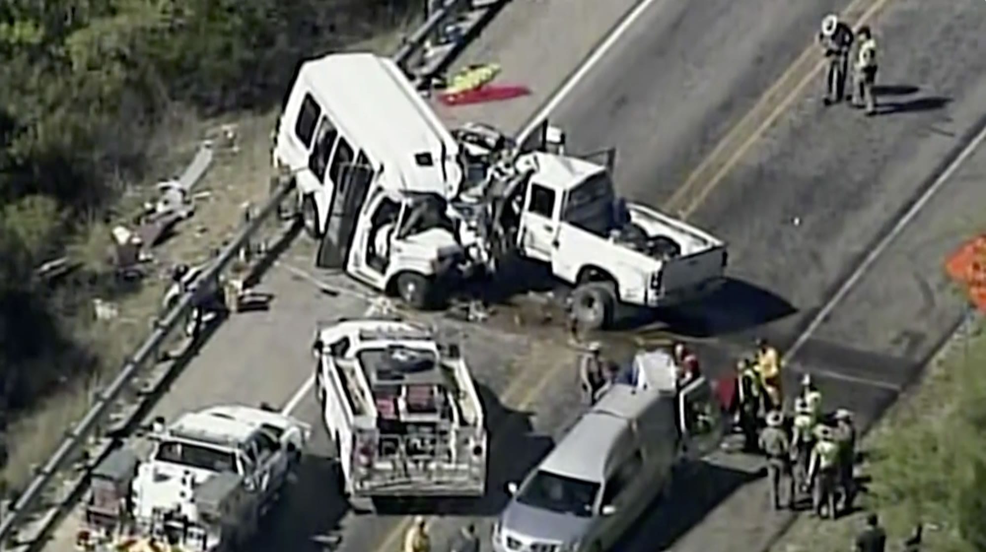 In this aerial image made from a video provided by KABB/WOAI authorities respond to a deadly crash involving a van carrying church members and a pickup truck on U.S. 83 outside Garner State Park in northern Uvalde County, Texas, Wednesday, March 29, 2017. The group of senior adults from First Baptist Church of New Braunfels, Texas, was returning from a retreat when the crash occurred, a church statement said.