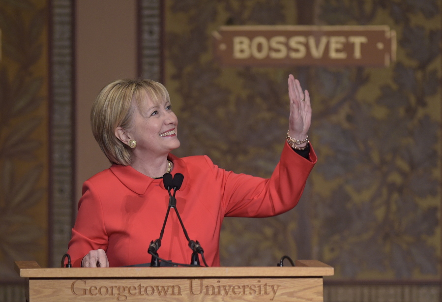 Former Secretary of State Hillary Clinton waves while speaking Friday, March 31, 2017, at Georgetown University in Washington, on the important role that women can play in international politics and peace building efforts.