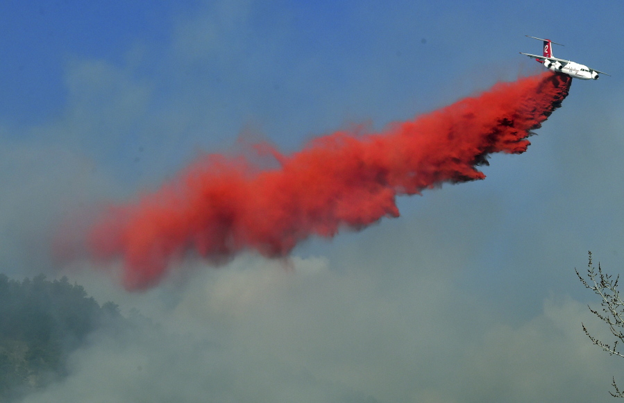 A slurry bomber drops on the fire west of Boulder, Colo., Sunday.