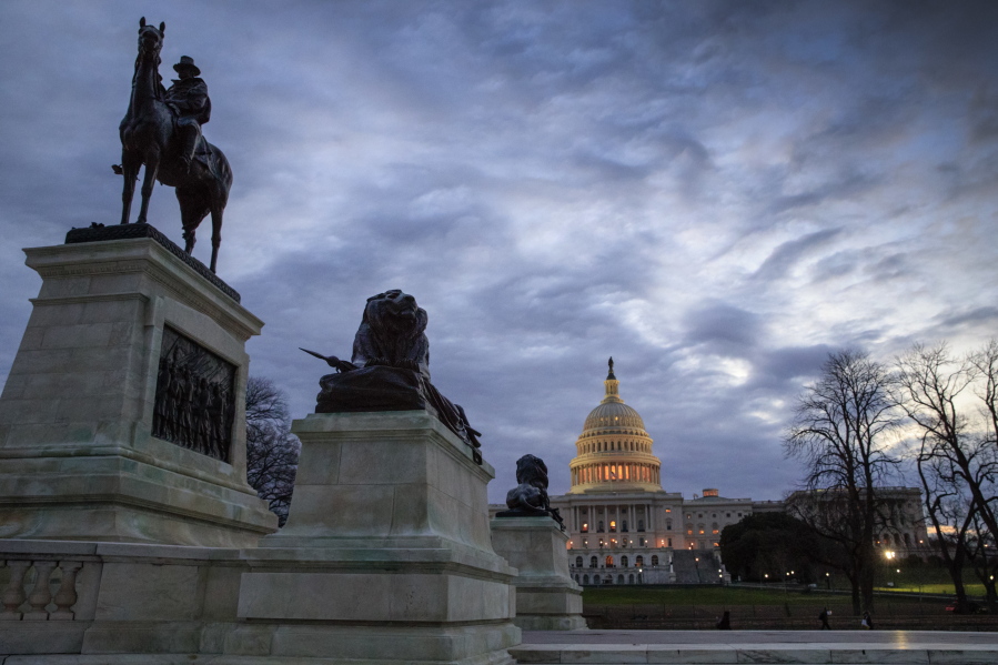 The Capitol is seen at dawn Thursday in Washington. A statue of Civil War Gen. Ulysses S. Grant is in the foreground at left. (j.