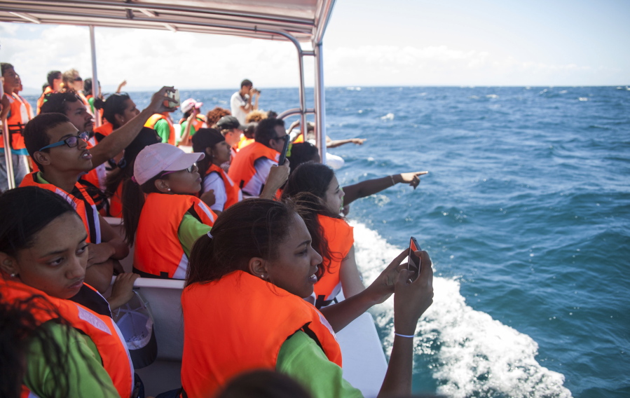Students from the St. Rose Institute for Deaf Assistance spot whales during a tour off Samana, Dominican Republic in March.