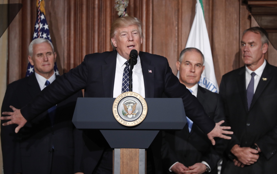 President Donald Trump, accompanied by from left, Vice President Mike Pence, Environmental Protection Agency  Administrator Scott Pruitt, and Interior Secretary Ryan Zinke, speaks at EPA headquarters in Washington, prior to signing an Energy Independence Executive Order. Environmental groups are preparing to go to court to battle Trump&#039;s efforts to roll back his predecessor&#039;s plans to curb global warming. But they say their first order of business is to mobilize a public backlash against an executive order Trump signed on Tuesday that eliminates many restrictions of fossil fuel production.