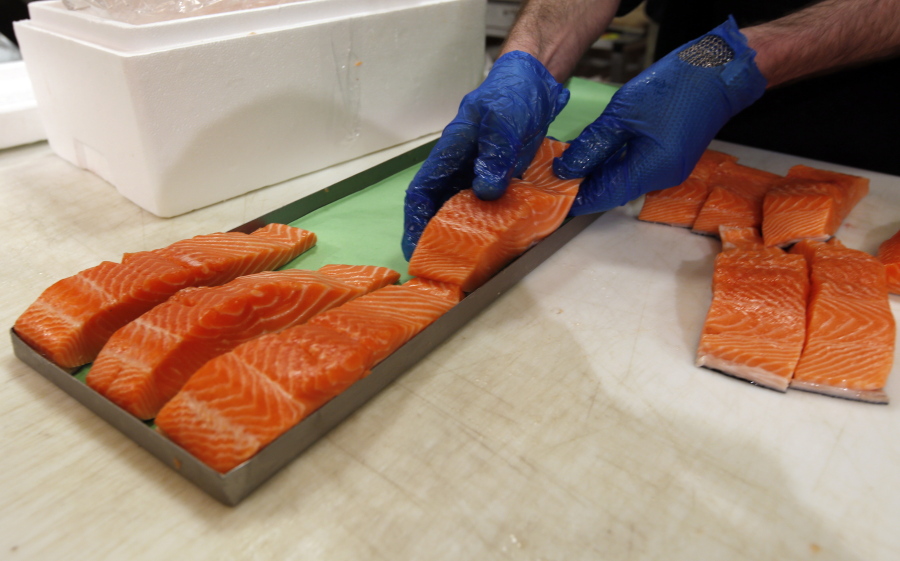 Canadian certified organic farm-raised King Salmon filets are placed on a tray in a store in Fairfax, Va.