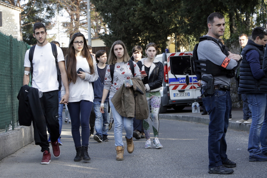 Students leave their high school after an attack in a high school in Grasse, southern France, on Thursday. A French high school principal and two others were shot Thursday at their school in southern France, and a 17-year-old student suspected of opening fire on them was arrested in a police raid, officials said.