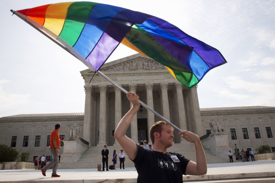 John Becker, 30, of Silver Spring, Md., waves a rainbow flag in support of gay marriage outside of the Supreme Court in Washington. LGBT advocates are questioning the Trump administration&#039;s quiet deletion of questions on sexuality from two federal surveys.