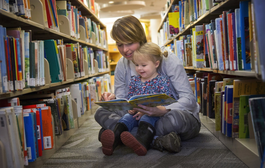 Jess Wood reads &quot;The Little Engine that Could&quot; to her daughter, Wynn Wood, 2, at the Eugene Public Library in Eugene., Ore.
