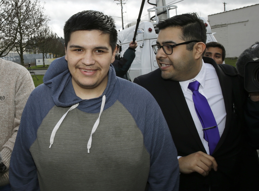 Daniel Ramirez Medina, left, walks with his attorney, Luis Cortes, right, after Ramirez was freed from custody Wednesday at the Northwest Detention Center in Tacoma. Ramirez had spent more than six weeks in immigration detention despite his participation in a program designed to prevent the deportation of those brought to the U.S. illegally as children. (AP Photo/Ted S.