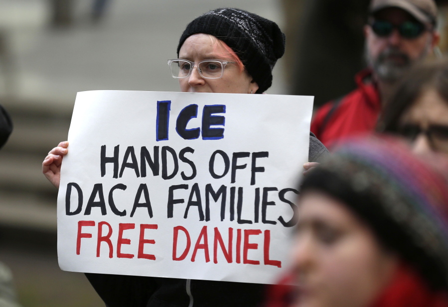 A protester holds a sign that reads &quot;ICE Hands Off DACA Families Free Daniel,&quot; during a demonstration in front of the federal courthouse in Seattle on Feb. 17.