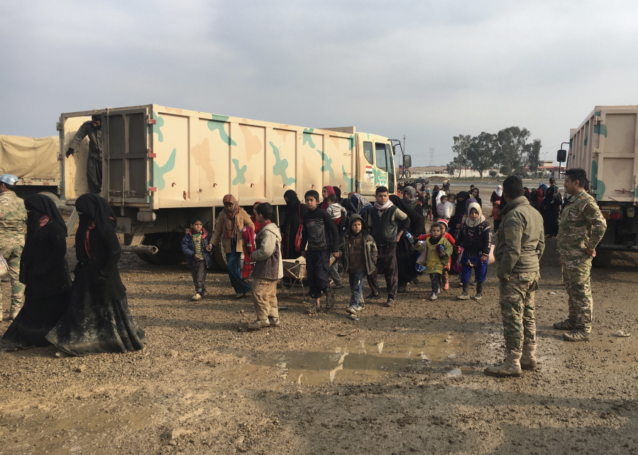 Civilians who fled clashes between Iraqi security forces and Islamic State group militants arrive to Iraqi Army base in the western side of Mosul, Iraq, Friday, March 3, 2017.
