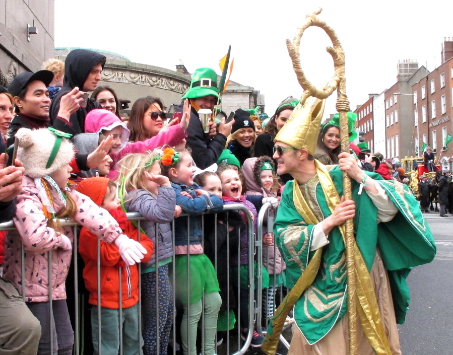Saint Patrick as portrayed by Irish actor Johnny Murphy clowns around with children watching the St. Patrick???s Day parade in Dublin, Ireland, Friday, March 17, 2017. An estimated half million tourists and Dubliners watched the parade, the focal point for a four-day festival that marks the start of Ireland&#039;s tourist season.