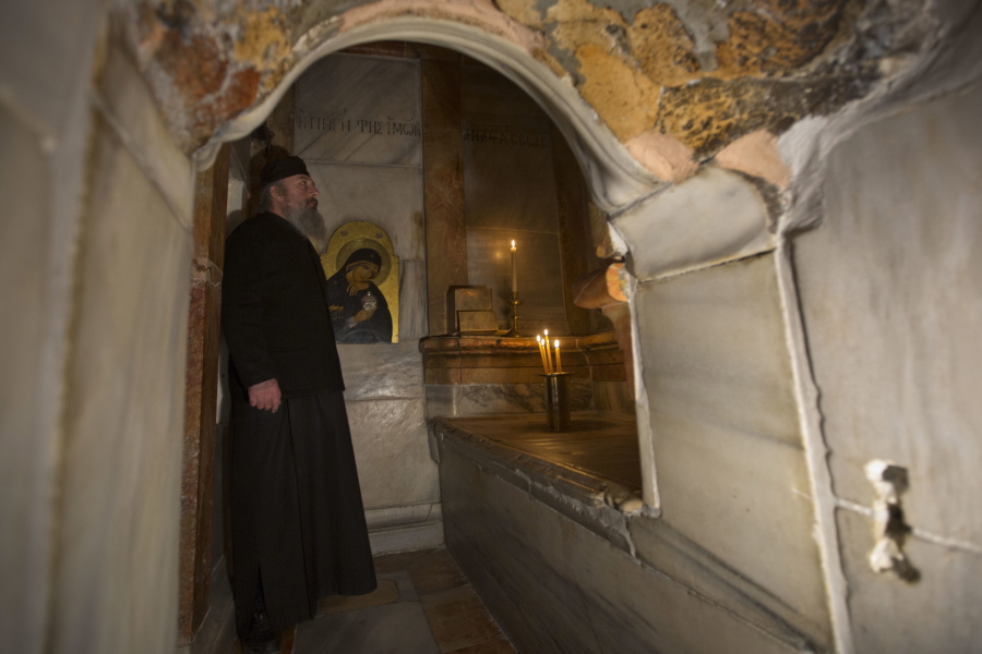A Greek priest stands Monday in the renovated Edicule in the Church of the Holy Sepulchre, believed to be the site of the burial of Jesus Christ, in Jerusalem&#039;s old city.