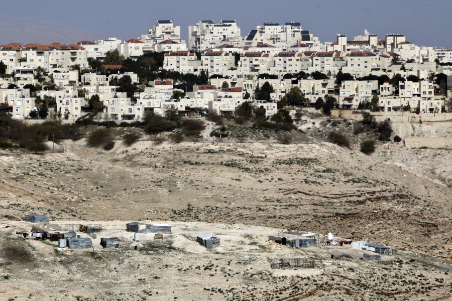 The Israeli settlement of Maaleh Adumim looms over Arab Bedouin shacks Jan. 22 in the West Bank. Yaakov Katz, a prominent West Bank settler, said Sunday that the number of Israelis living in the West Bank has soared by nearly one quarter over the past five years to over 420,000 people.