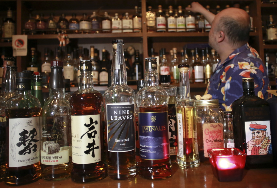 Shot bar Zoetrope owner and bartender Atsushi Horigami adjusts the bottles of Japan-made whisky at his bar in Tokyo. Zoetrope, a tiny bar in a dingy building in a Tokyo backstreet, is famous among whisky lovers for specializing in Japanese whisky. Horigami says Japanese whisky&#039;s &quot;unpredictability&quot; is what makes it so special.