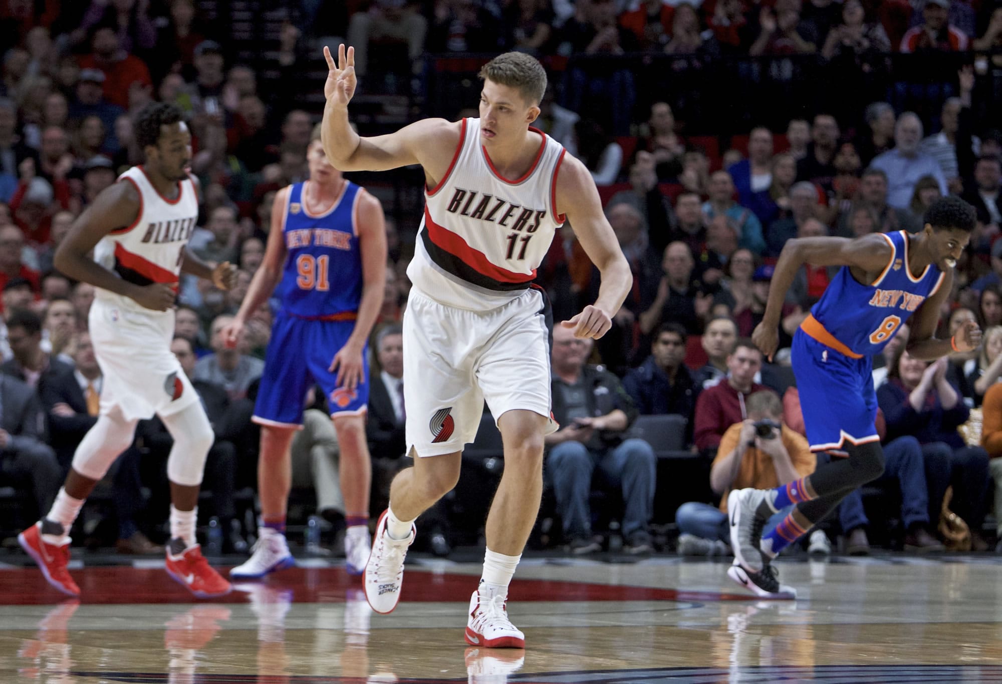 Portland Trail Blazers forward Meyers Leonard signels after making a 3-point basket against the New York Knicks during the first half of an NBA basketball game in Portland, Ore., Thursday, March 23, 2017.