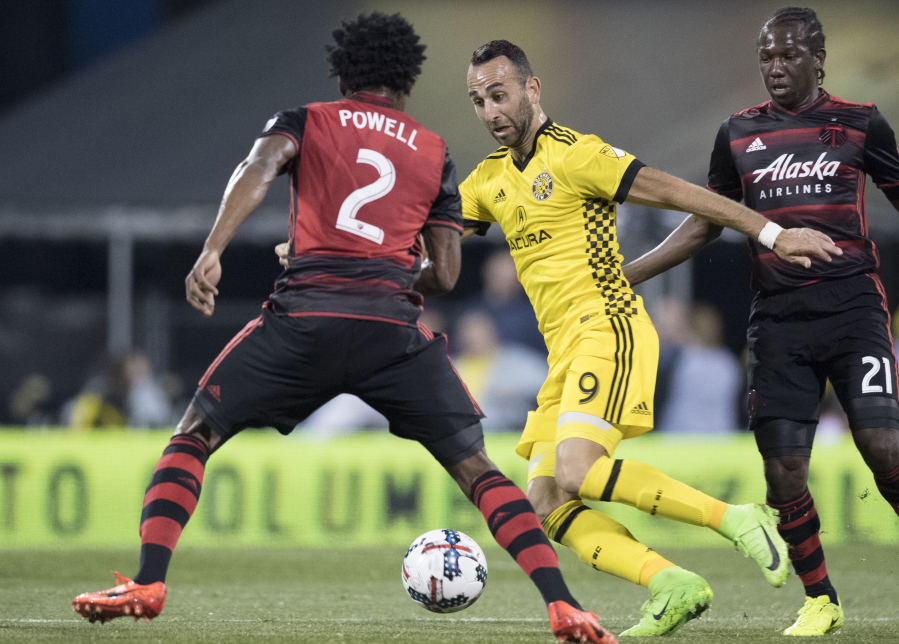 Columbus Crew forward Justin Meram advances the ball past Portland Timbers defender Alvas Powell during the first half of an MLS soccer match, Saturday, March 25, 2017, in Columbus, Ohio.