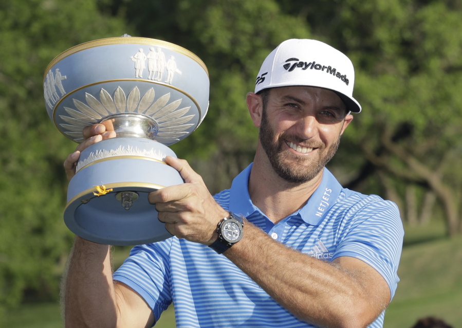 Dustin Johnson holds his trophy after defeating Jon Rahm of Spain at the Dell Technologies Match Play golf tournament at Austin County Club, Sunday, March 26, 2017, in Austin, Texas.