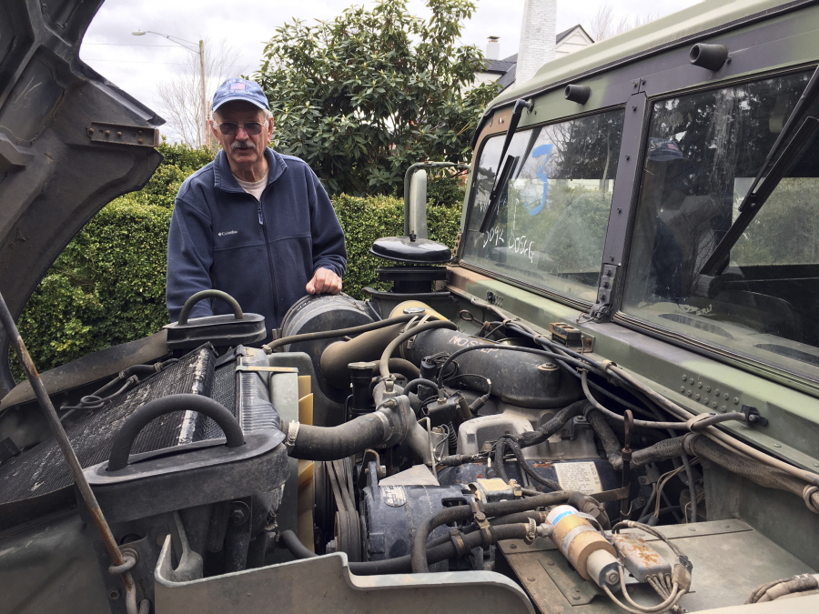 Hank Porter, 75, mayor of Stayton, Ore., stands with his 1990 military surplus Humvee outside his residence March 2. Oregon could be the first state to allow street use of retired military Humvees should state lawmakers approve a bill that was proposed at the request of Porter, who wants to tow war veterans through parades in Stayton during Fourth of July celebrations.