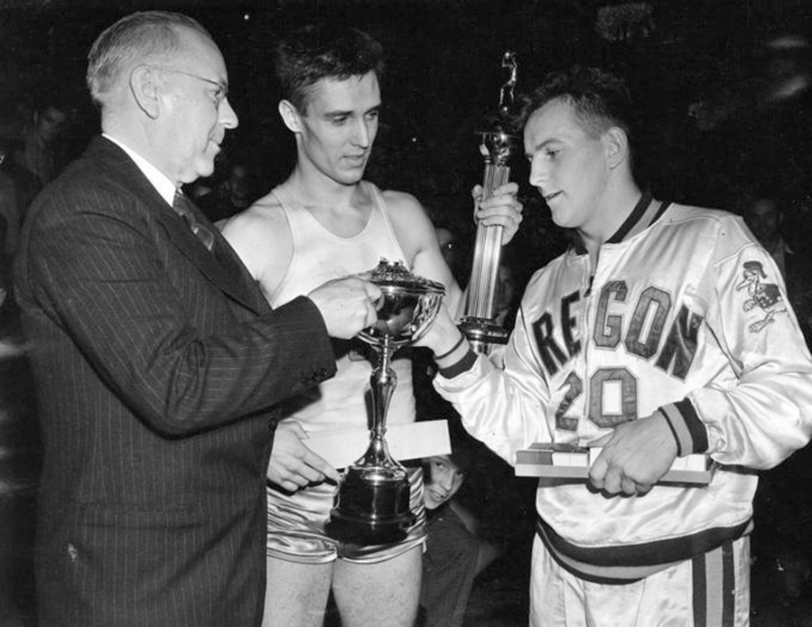 In this March 27, 1939 photo, provided by the University of Oregon Archives, Oregon&#039;s Bobby Anet, right is presented the trophy by Big Ten Commissioner John Griffith, left, after Oregon defeated Ohio State 46-33 in the National Collegiate basketball tournament at Northwestern University in Evanston, Ill. A collision broke off the little man on top the trophy. Ohio State All American Jimmy Hull, center, looks on. Oregon is headed to Phoenix to face North Carolina in the national semifinals on Saturday. Oregon hasn???t been this close to the title game since the team won the first NCAA Tournament in 1939.
