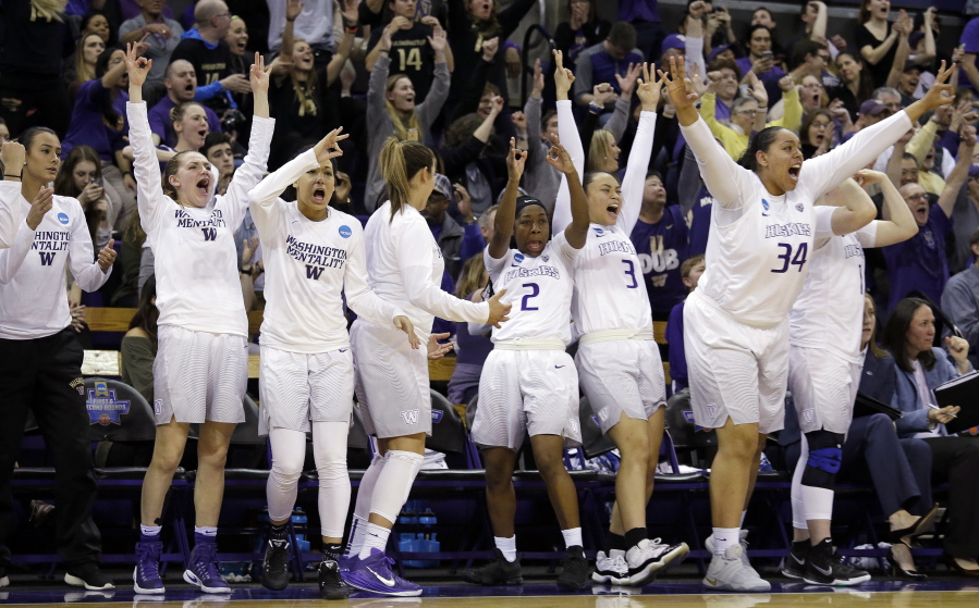 Washington players on the bench react to a 3-point basket during their 108-82 win over Oklahoma on Monday.