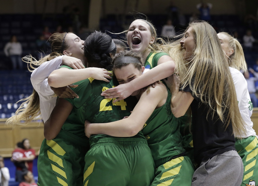 Teammates hug Oregon&#039;s Ruthy Hebard (24) following Hebard&#039;s late shot to give their team a 71-70 win over Temple during a first-round game in the NCAA women&#039;s college basketball tournament in Durham, N.C., Saturday, March 18, 2017.