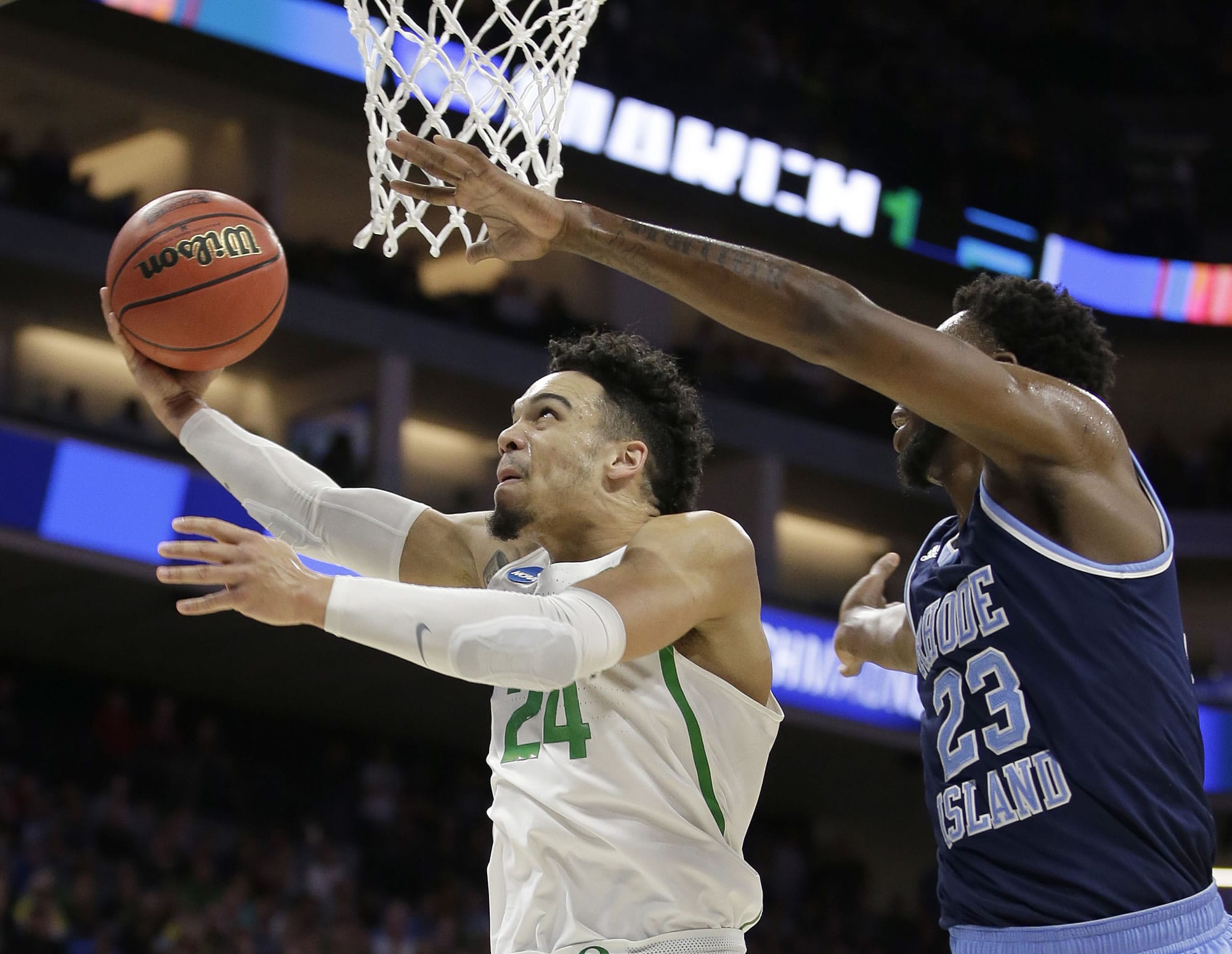 Oregon Ducks, Dillon Brooks, left, goes to the basket against Rhode Island forward Kuran Iverson during the first half of a second-round game of the NCAA men's college basketball tournament in Sacramento, Calif., Sunday, March 19, 2017.