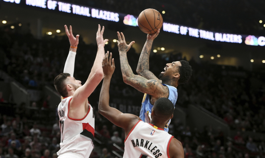 Denver Nuggets forward Wilson Chandler shoots the ball over Portland Trail Blazers center Jusuf Nurkic, left, and Portland Trail Blazers forward Maurice Harkless, right, during the first half of an NBA basketball game in Portland, Ore., Tuesday, March 28, 2017.