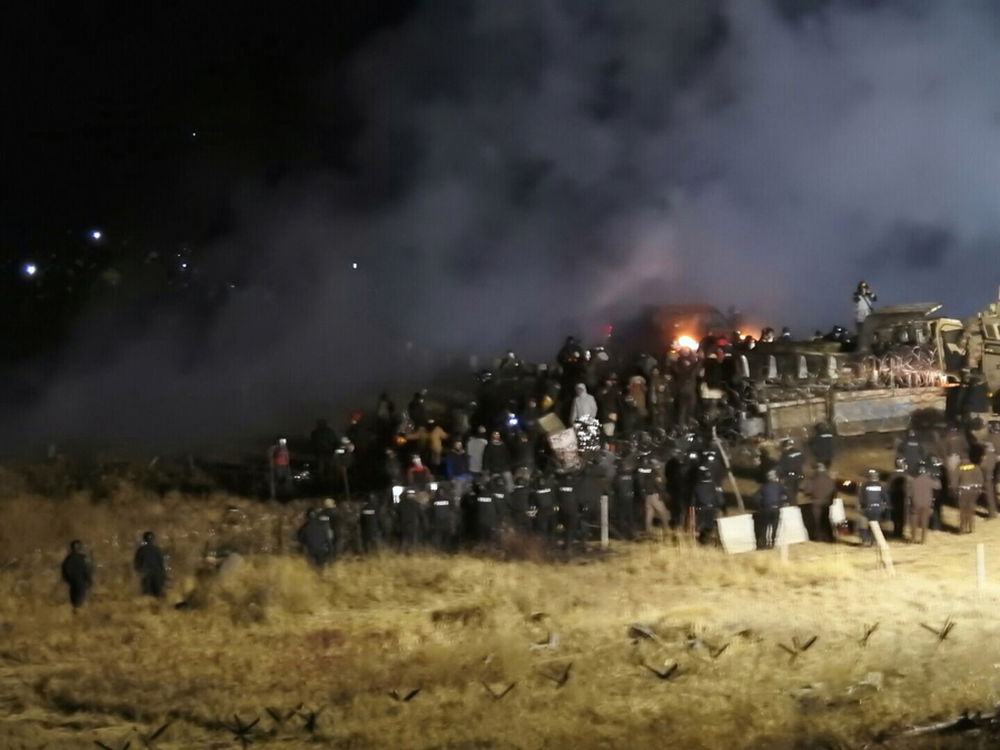 Law enforcement and protesters clash near the site of the Dakota Access pipeline near Cannon Ball, N.D., on Nov. 20. Prosecutors have withdrawn a subpoena for Steve Martinez, a pipeline opponent from Williston, N.D., who had been ordered to testify about the violent clash in November.