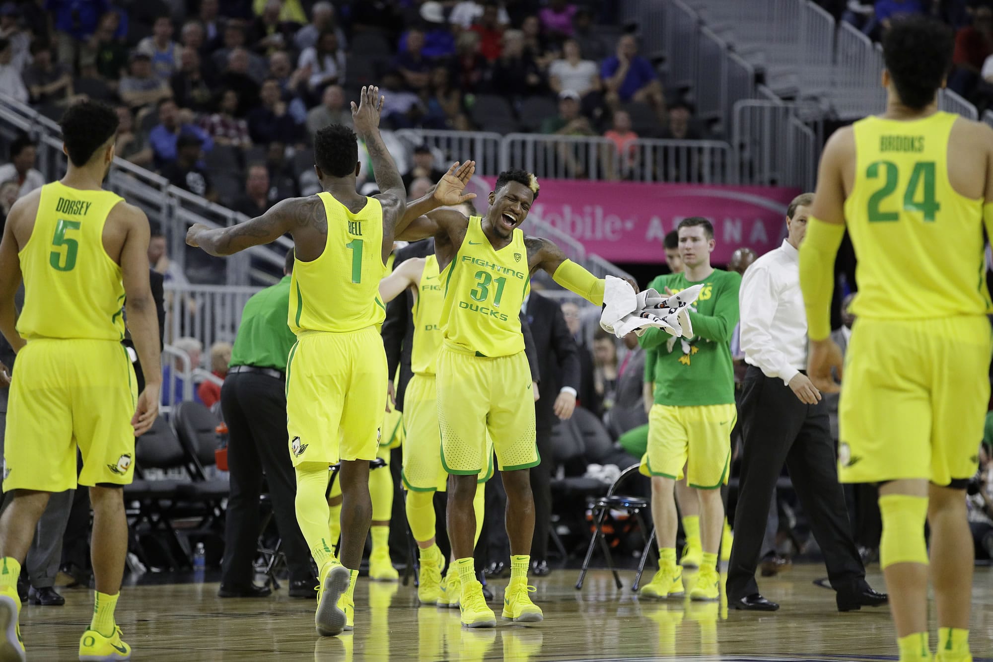 Oregon's Dylan Ennis (31) and Jordan Bell (1) celebrate after a play against California during the second half of an NCAA college basketball game in the semifinals of the Pac-12 men's tournament Friday, March 10, 2017, in Las Vegas. Oregon won 73-65.