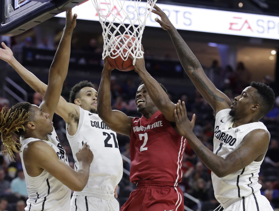 Washington State&#039;s Ike Iroegbu (2) shoots against Colorado&#039;s Xavier Johnson, left, Derrick White, second from left, and Wesley Gordon during the second half of an NCAA college basketball game in the first round of the Pac-12 men&#039;s tournament Wednesday, March 8, 2017, in Las Vegas. Colorado won 73-63.