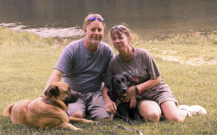 John and Amy Hunter with their dogs, Apollo, left, and Rubi, a black Labrador retriever, in Brown County State Park south of their home in Indianapolis, Ind., in 2015. The couple is childless by choice and Amy is a stay-at-home pet mom.