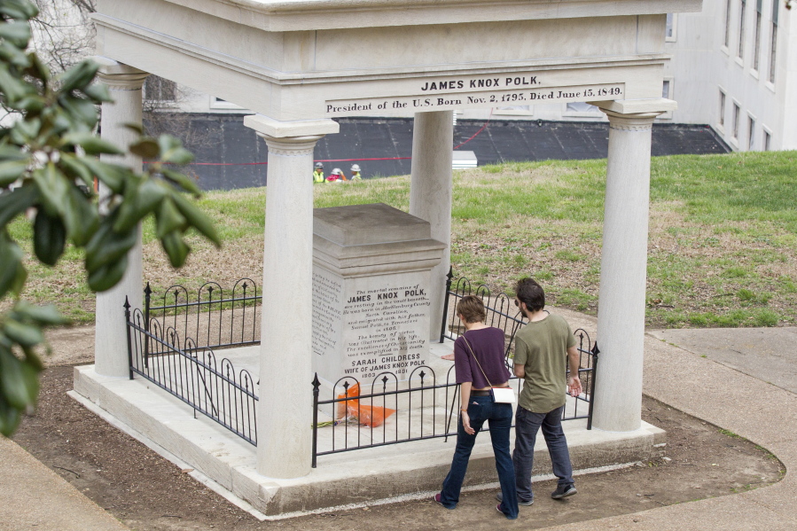 Visitors look at the burial place of former President James K. Polk and his wife, Sarah Polk, on the grounds of the state Capitol in Nashville, Tenn., Friday. A resolution being considered in the state Legislature calls for exhuming their bodies and moving them to the James K. Polk Home and Museum in Columbia, Tenn.