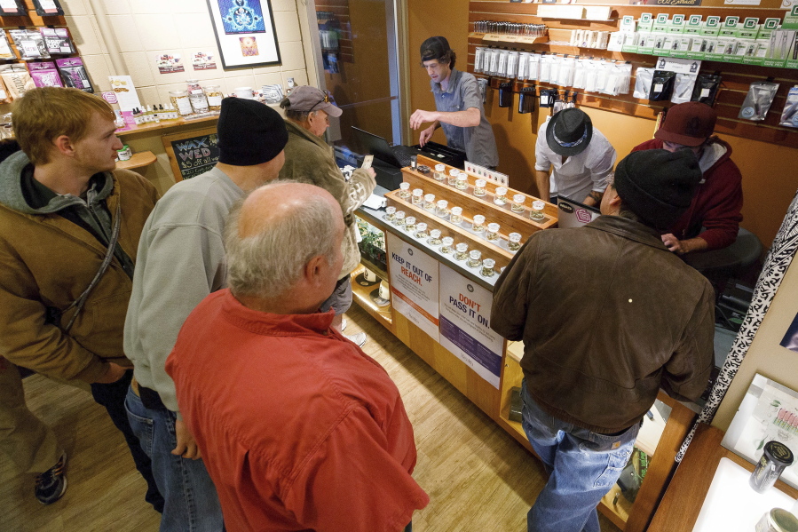 Employees of Amazon Organics, a pot dispensary in Eugene, Ore., help customers purchase recreational marijuana on Oct. 1, 2015. Amid concerns of a federal crackdown, lawmakers in Oregon are moving to protect the personal information of marijuana customers.