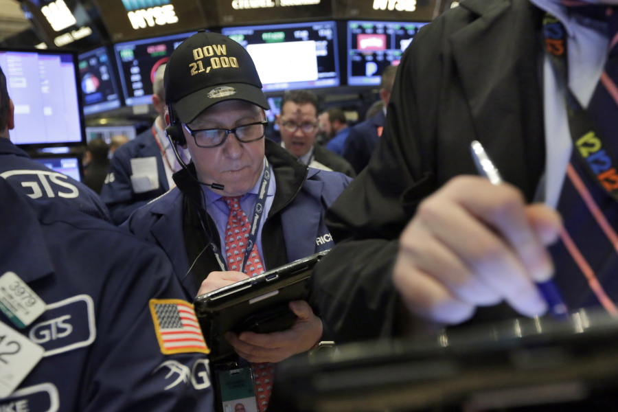 Trader Richard Cohen wears a &quot;Dow 21,000&quot; cap Wednesday as he works on the floor of the New York Stock Exchange. Excitement that President Donald Trump will drive business-friendly policies is only one of the reasons behind the stock market&#039;s recent surge. The economy is getting stronger, and so are corporate profits.