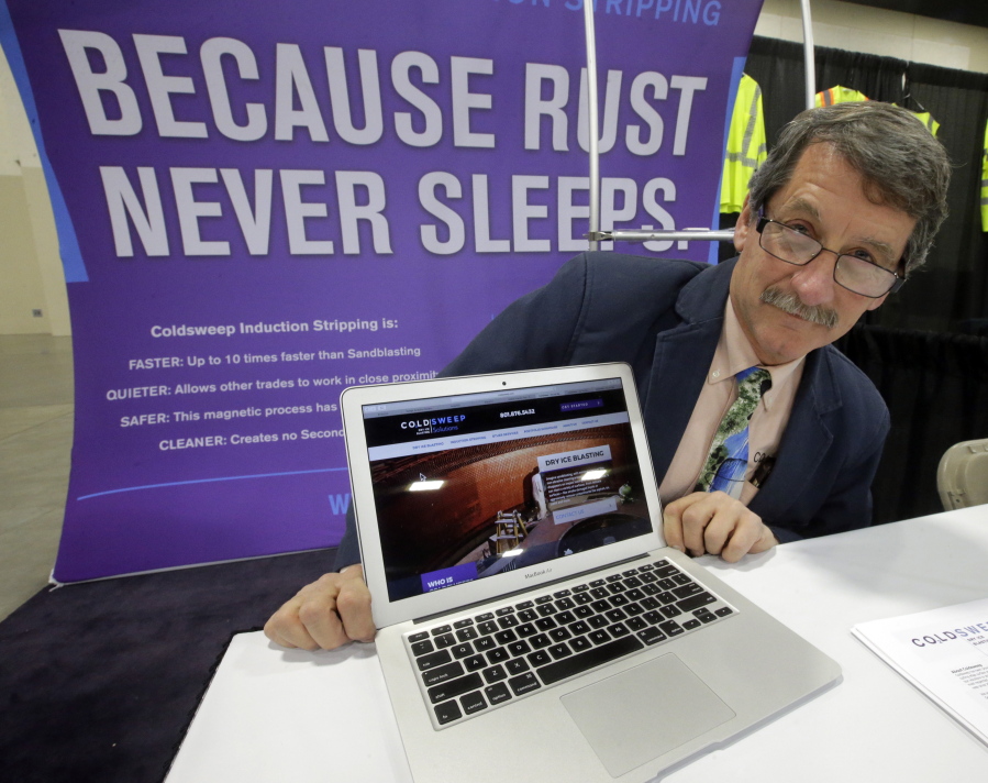 Randell Heath poses next to a laptop displaying his company&#039;s website, in Sandy, Utah. Heath&#039;s sandblasting company, near Salt Lake City, had its website hacked and turned into a store selling Viagra and Cialis.