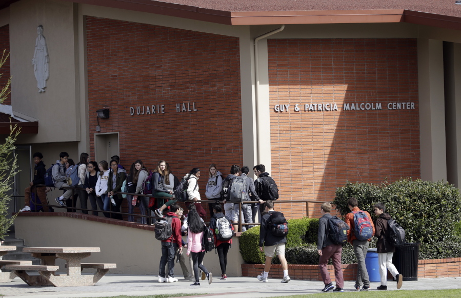 Students walk between buildings Friday at St. Francis High School in Mountain View, Calif. The red-hot IPO debut of Snap this week not only placed the Southern California startup at $35 billion in value, it also made millions for the high school.