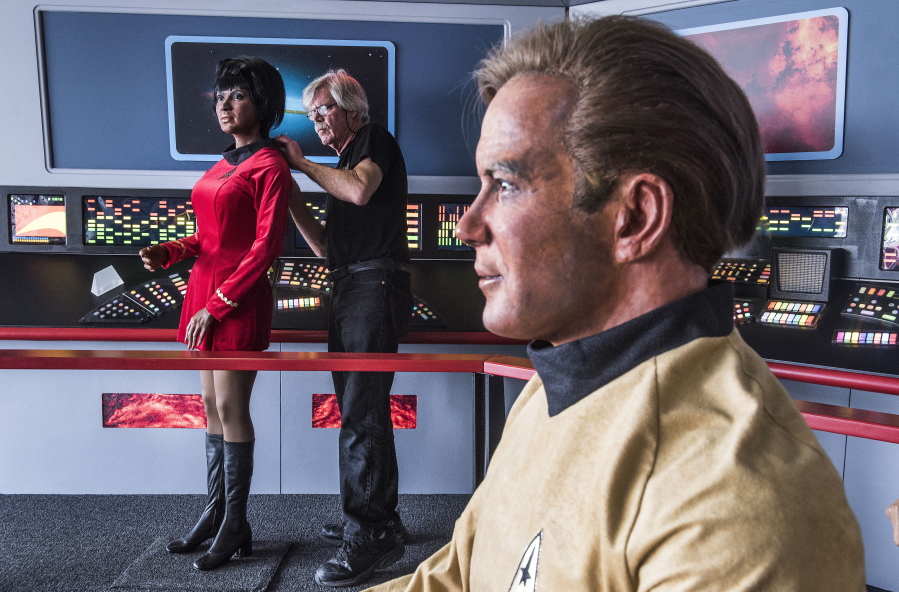 Steve Greenthal adjusts the wax head of Star Trek character Uhura on its body next to a figure of Captain Kirk at the Fullerton Airport in Fullerton, Calif.