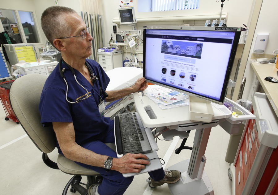 Dr. Garen Wintemute, an emergency room physician at the University of California, Davis, Medical Center, shows the website of the Bureau of Alcohol, Tobacco and Firearms, on a computer in the hospital Thursday in Sacramento, Calif.