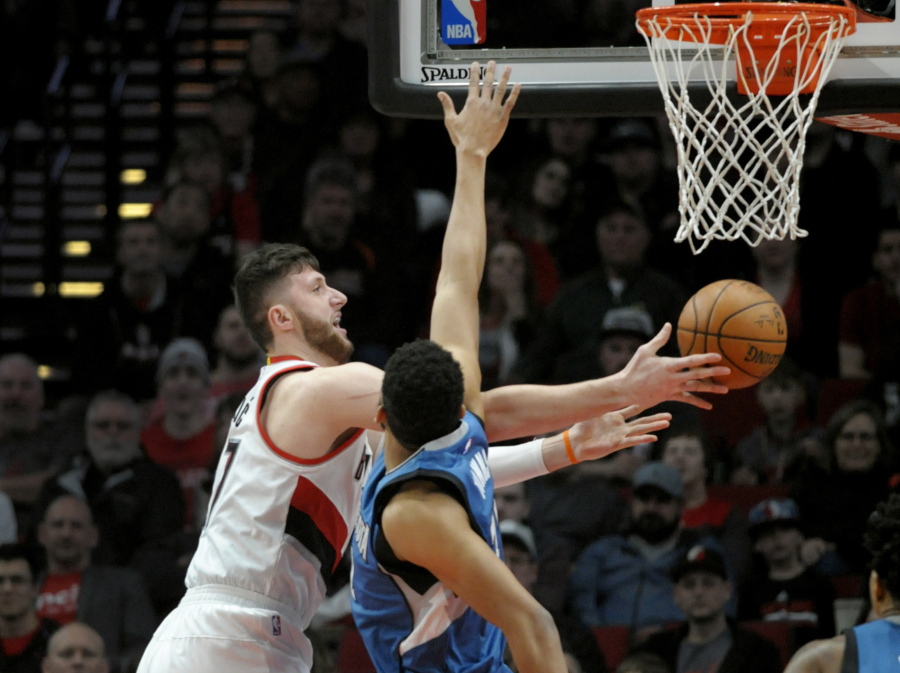 Portland Trail Blazers center Jusuf Nurkic drives to the basket on Minnesota Timberwolves center Karl-Anthony Towns during the first half of an NBA basketball game in Portland, Ore., Saturday, March 25, 2017.