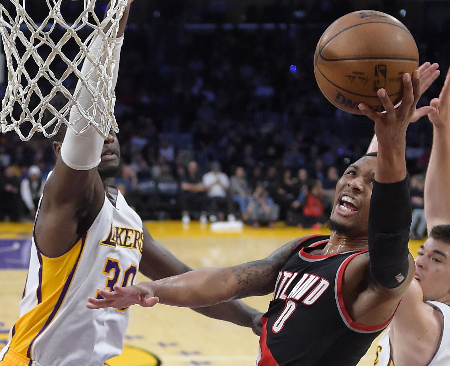 Portland Trail Blazers guard Damian Lillard, right, shoots as Los Angeles Lakers forward Julius Randle defends during the first half of an NBA basketball game, Sunday, March 26, 2017, in Los Angeles. (AP Photo/Mark J.