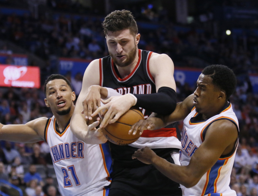 Oklahoma City Thunder forward Andre Roberson (21) and guard Semaj Christon, right, try to take the ball away from Portland Trail Blazers center Jusuf Nurkic, center, in the fourth quarter of an NBA basketball game in Oklahoma City, Tuesday, March 7, 2017. Portland won 126-121.