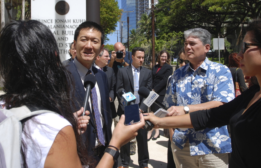Hawaii Attorney General Douglas Chin speaks outside federal court in Honolulu on Wednesday. A federal judge in Hawaii questioned government attorneys Wednesday who urged him to narrow his order blocking President Donald Trump&#039;s travel ban because suspending the nation&#039;s refugee program has no effect on the state. U.S. District Judge Derrick Watson is hearing arguments on whether to extend his temporary order until Hawaii&#039;s lawsuit works its way through the courts. Even if he does not issue a longer-lasting hold on the ban, his temporary block would stay in place until he rules otherwise.