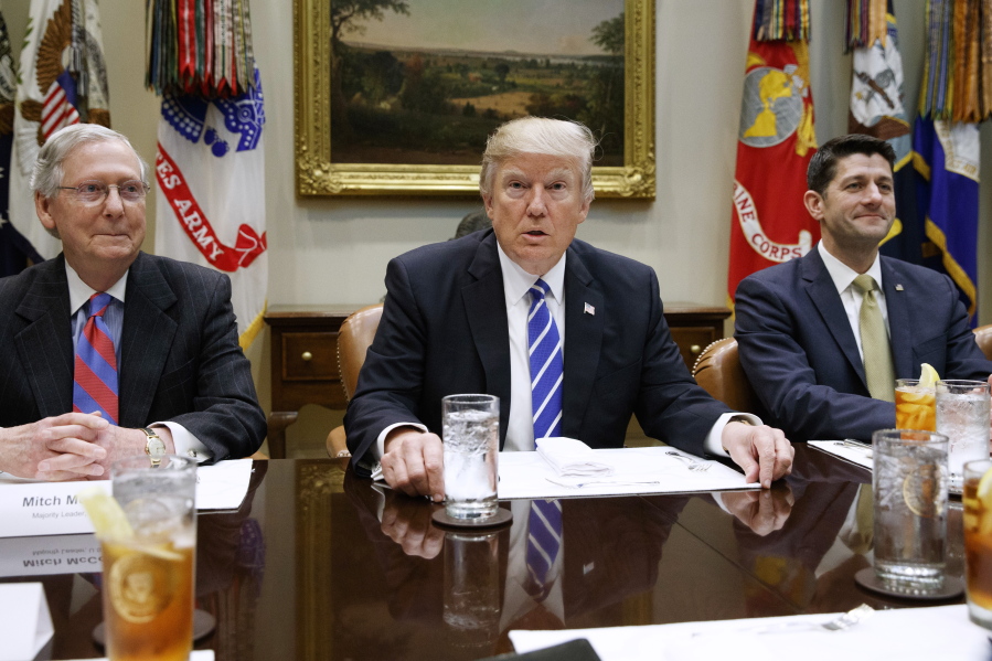 President Donald Trump, flanked by Senate Majority Leader Mitch McConnell of Ky. and House Speaker Paul Ryan of Wis., hosts a meeting with House and Senate leadership, Wednesday, March 1, 2017, in the Roosevelt Room of the White House in Washington.